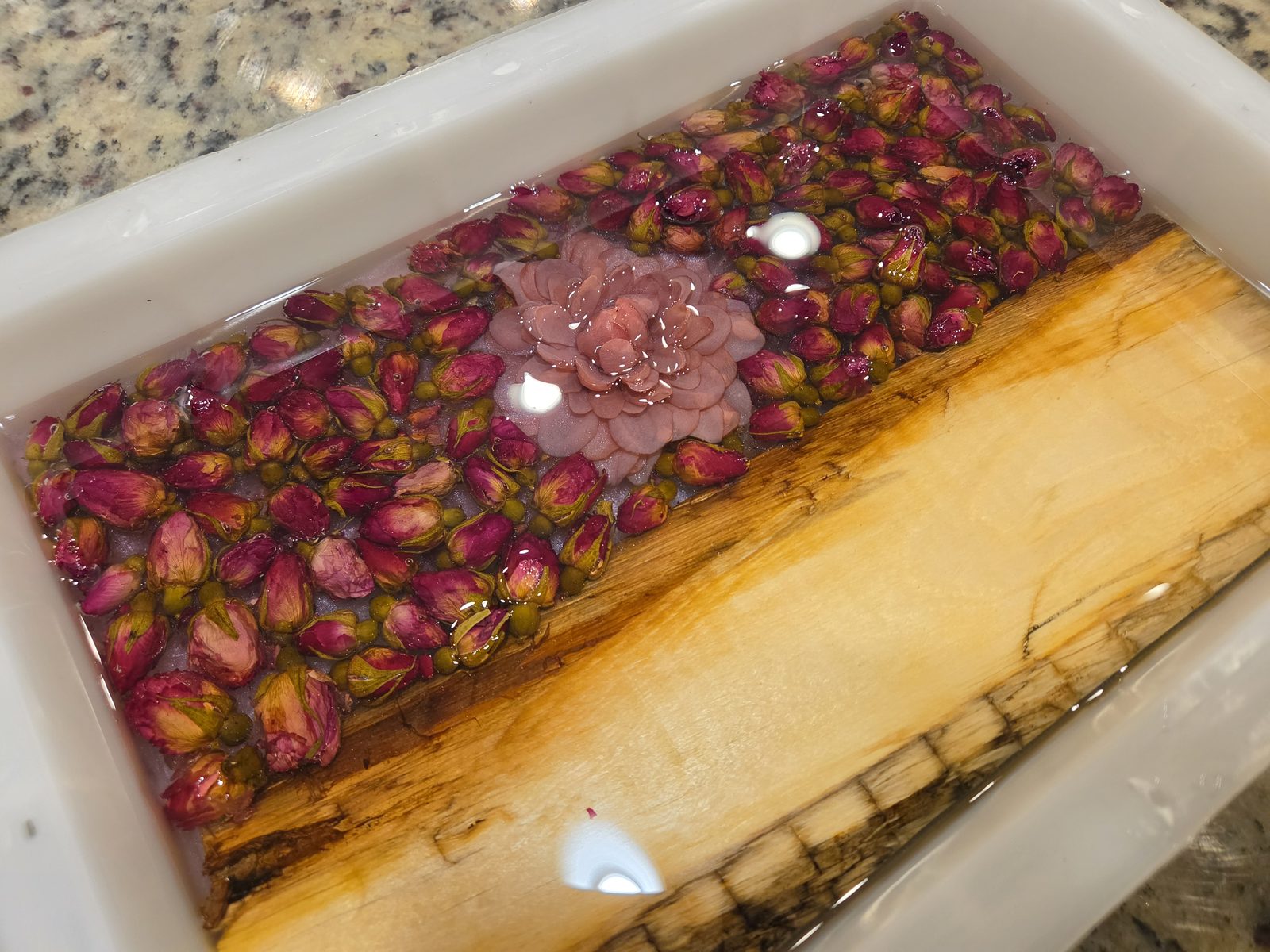 Rose buds being preserved in resin